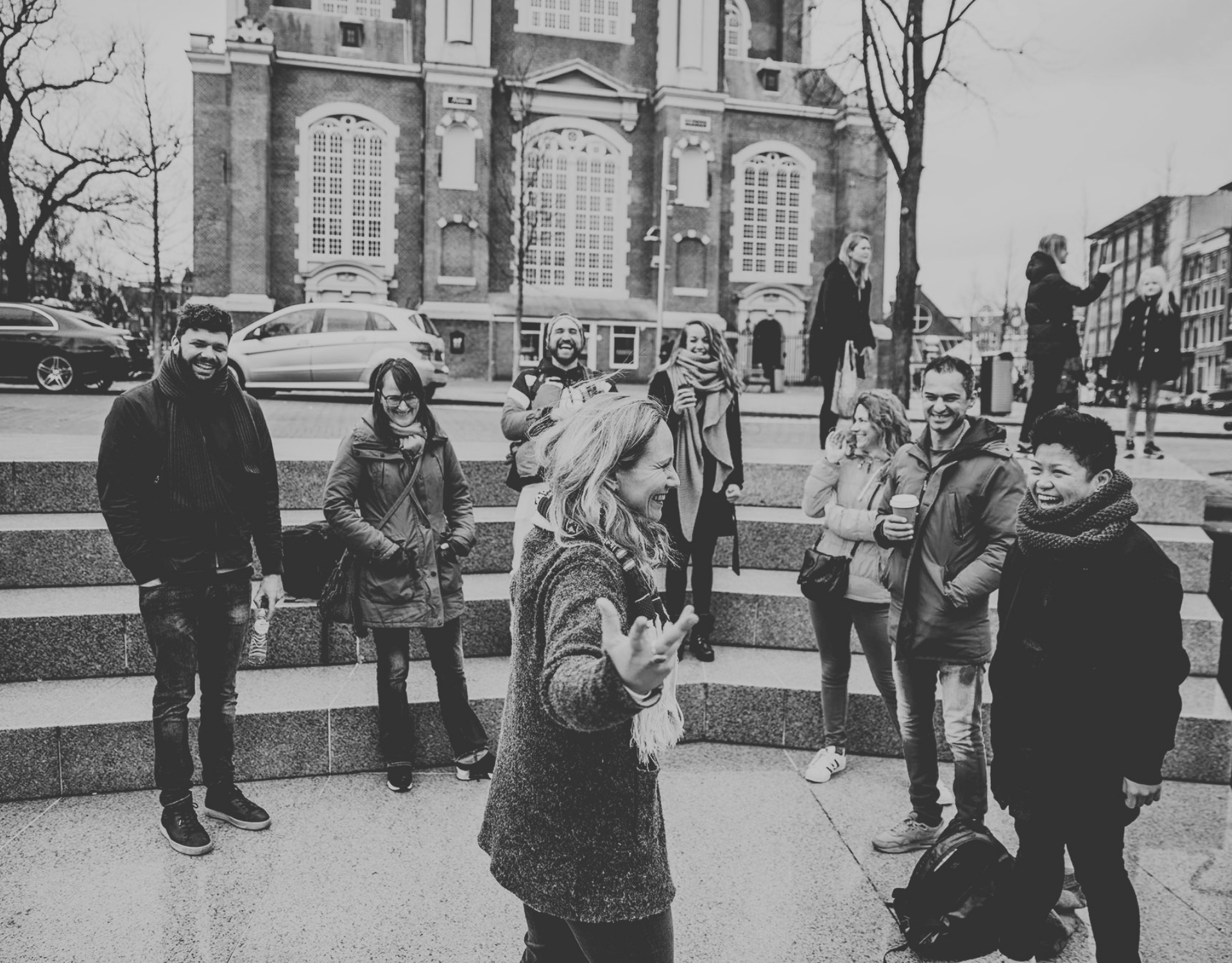 a tour guide speaking to a group at Homomonument Amsterdam