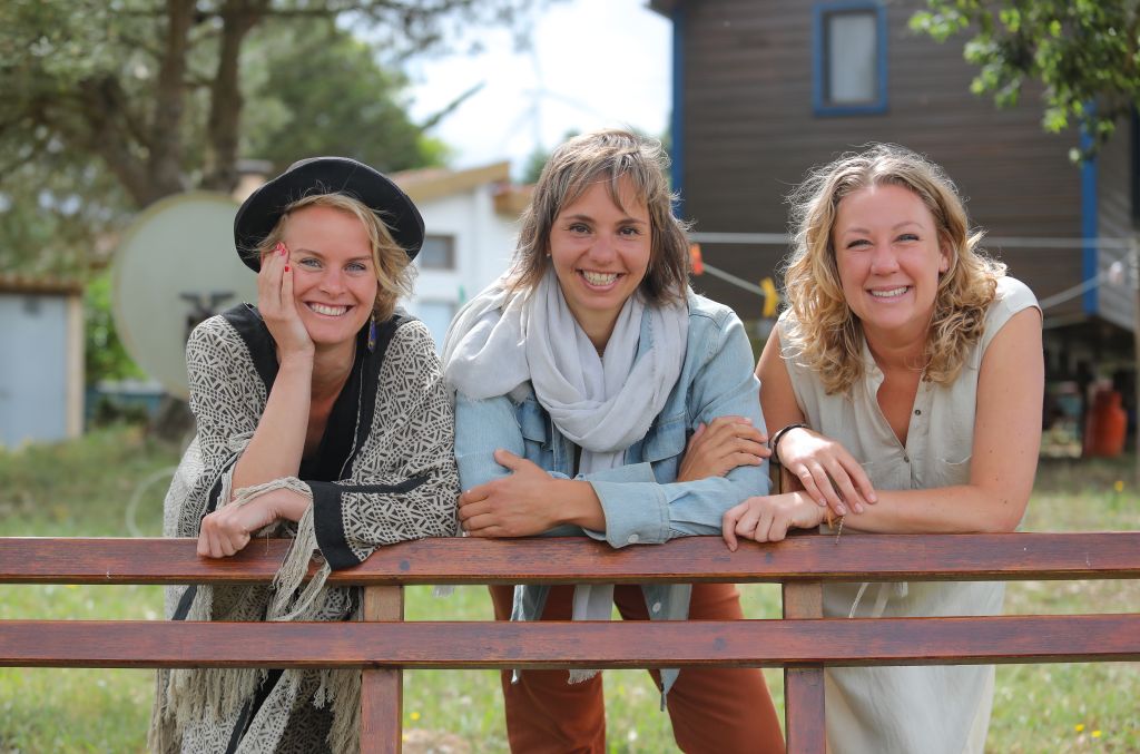 Three women posing at a ranch